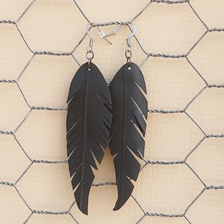 a pair of earrings shaped like feathers